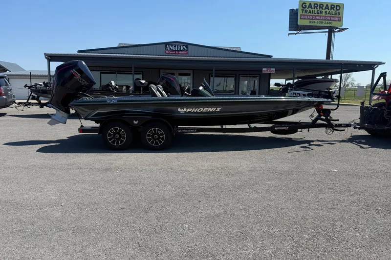 The Image of 2026 Phoenix 721 ZXL boat on trailer at dealership parking lot. - 1