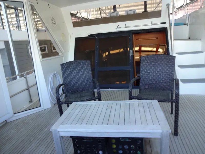 Slide: The Image of Deck area of a 1996 President 545 yacht with seating. - 13