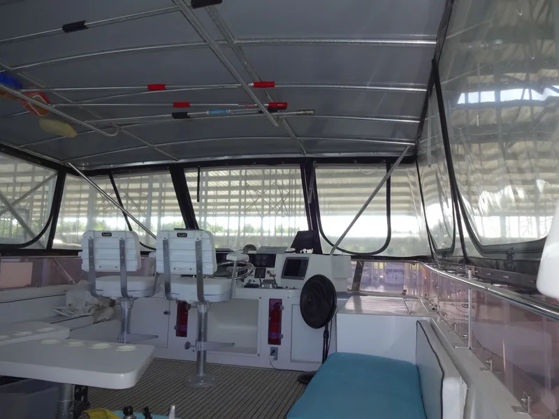 Slide: The Image of Interior of a 1996 President 545 yacht, featuring helm and seating area. - 14
