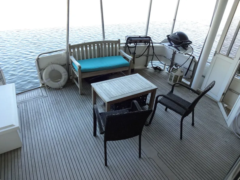 Slide: The Image of Deck of a 1996 President 545 boat with seating area and grill. - 21
