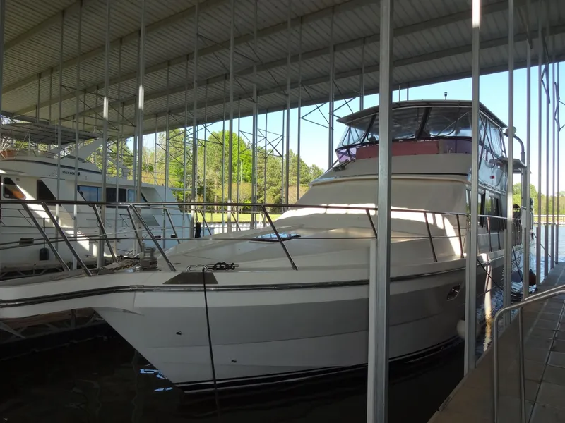 Slide: The Image of 1996 President 545 yacht docked under cover, serene setting. - 3