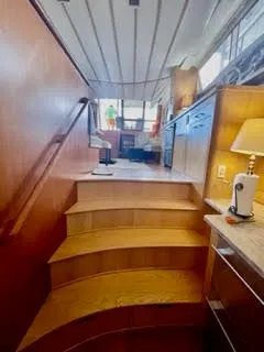 Slide: The Image of Interior of a 1996 President 545 yacht with wooden stairs. - 42