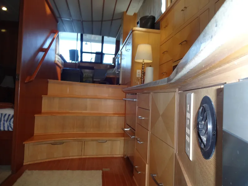 Slide: The Image of Interior of a 1996 President 545 yacht with wooden stairs and cabinets. - 43
