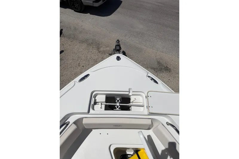 Slide: The Image of Bow view of 2023 Sea Hunt Ultra 234 boat, featuring anchor storage and seating area. - 10