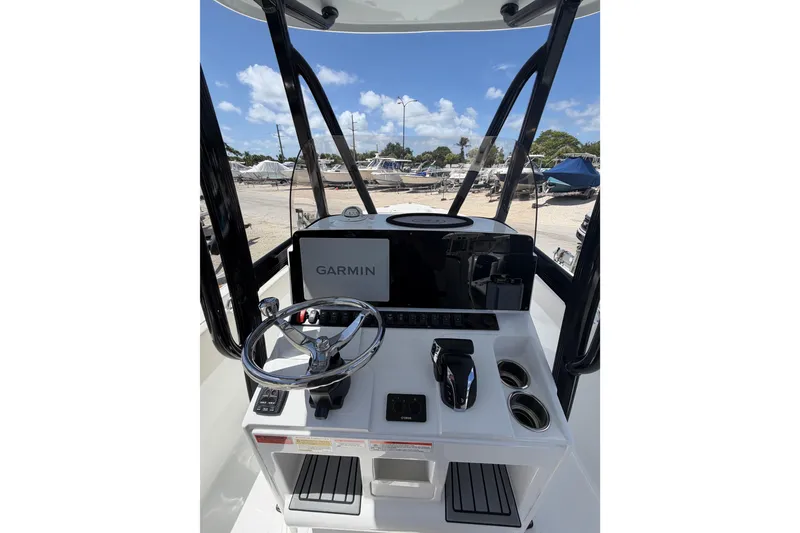 Slide: The Image of 2023 Sea Hunt Ultra 234 boat console with Garmin navigation, steering wheel, and controls. - 11