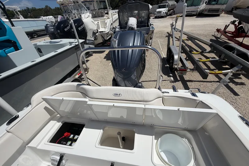 Slide: The Image of 2023 Sea Hunt Ultra 234 boat interior with engine and storage compartments. - 14