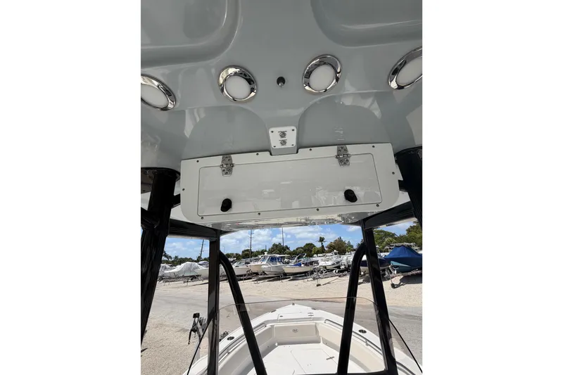 Slide: The Image of 2023 Sea Hunt Ultra 234 boat console with storage compartment and overhead view. - 19