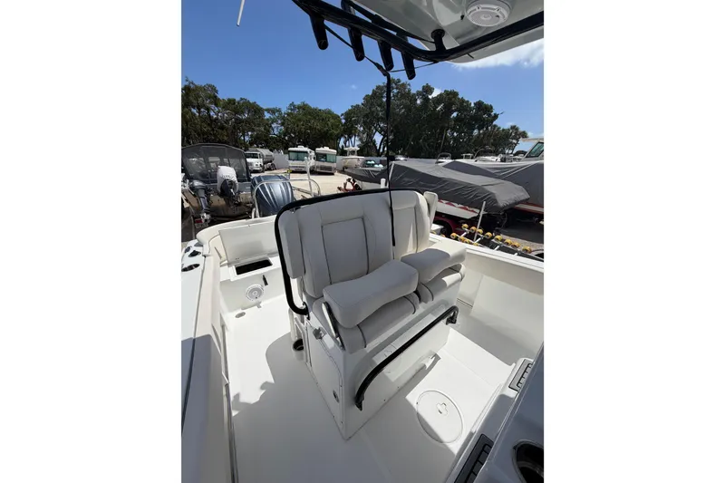 Slide: The Image of 2023 Sea Hunt Ultra 234 boat interior with cushioned seating and storage compartments. - 20