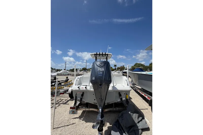 Slide: The Image of 2023 Sea Hunt Ultra 234 boat with Yamaha 250 V6 engine, parked outdoors. - 3