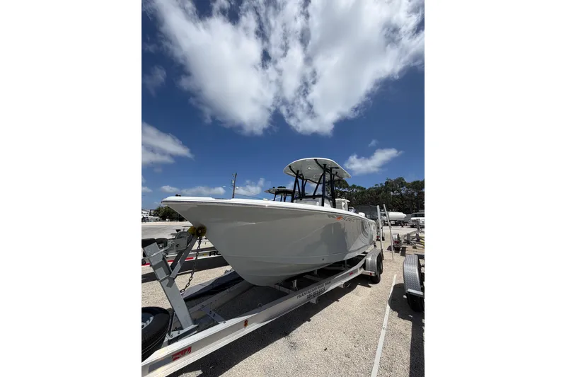 Slide: The Image of 2023 Sea Hunt Ultra 234 boat on trailer under a clear blue sky. - 4