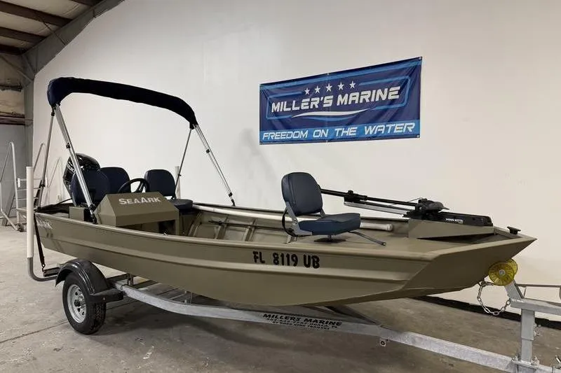 Slide: The Image of 2026 SeaArk 1648 MV Special boat on trailer at Miller's Marine showroom. - 1