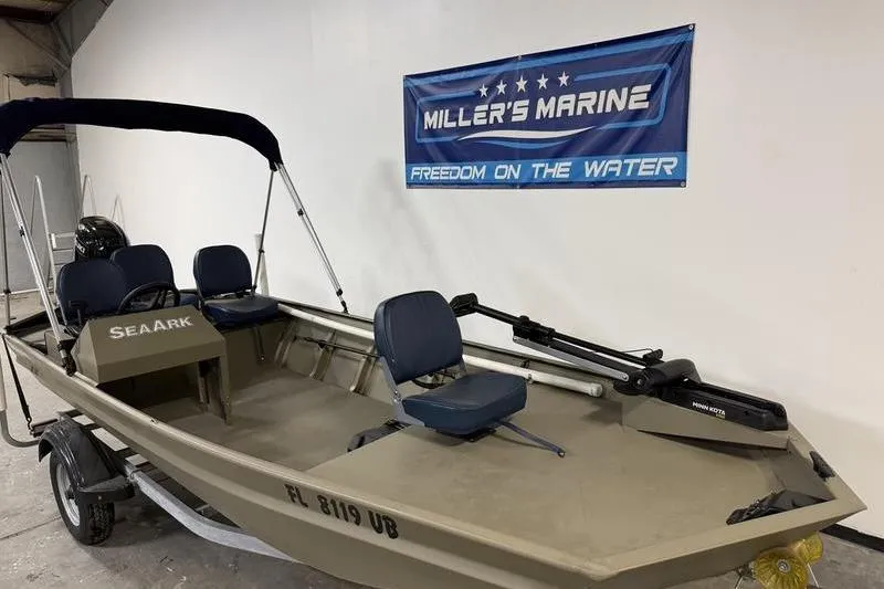 Slide: The Image of 2026 SeaArk 1648 MV Special boat displayed at Miller's Marine showroom. - 2