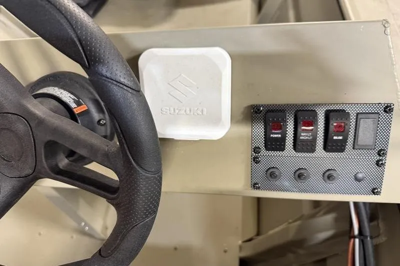 Slide: The Image of Steering wheel and control panel of 2026 SeaArk 1648 MV Special boat. - 7