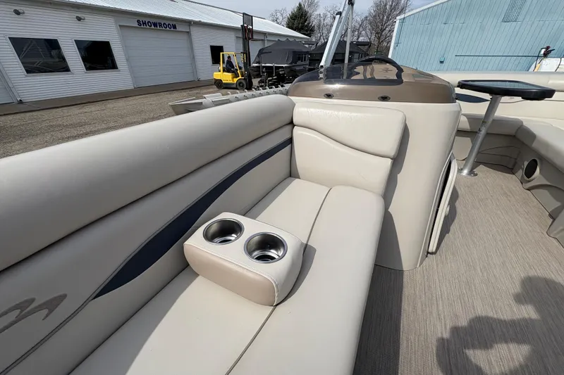 Slide: The Image of 2018 Bennington 188 SL pontoon boat interior with beige seating and cup holders. - 12