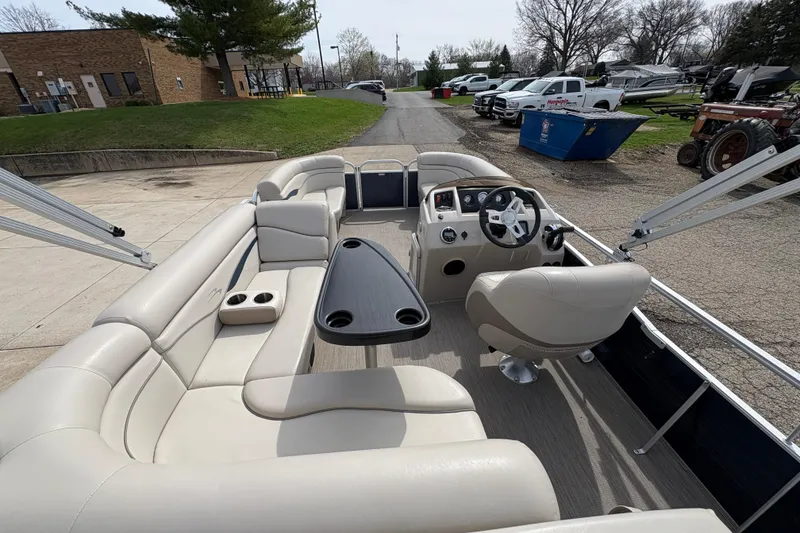 Slide: The Image of 2018 Bennington 188 SL pontoon boat interior with beige seating and steering console. - 20