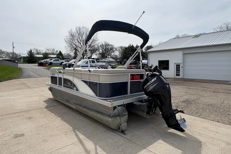 Slide: The Image of 2018 Bennington 188 SL pontoon boat with Mercury outboard motor on driveway. - 3