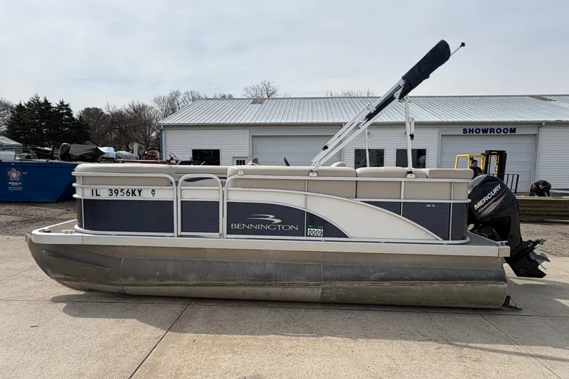 Slide: The Image of 2018 Bennington 188 SL pontoon boat with Mercury engine, parked outside a showroom. - 4