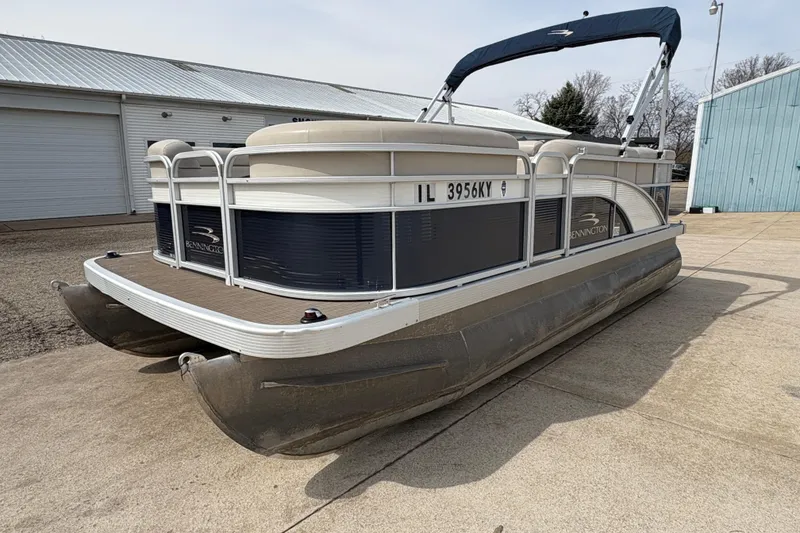 Slide: The Image of 2018 Bennington 188 SL pontoon boat parked on concrete near a warehouse. - 5