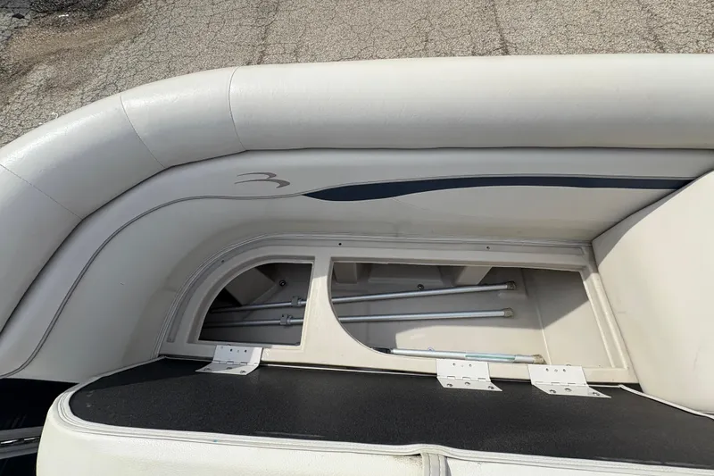 Slide: The Image of 2018 Bennington 188 SL boat interior storage compartment with cushioned seating. - 9