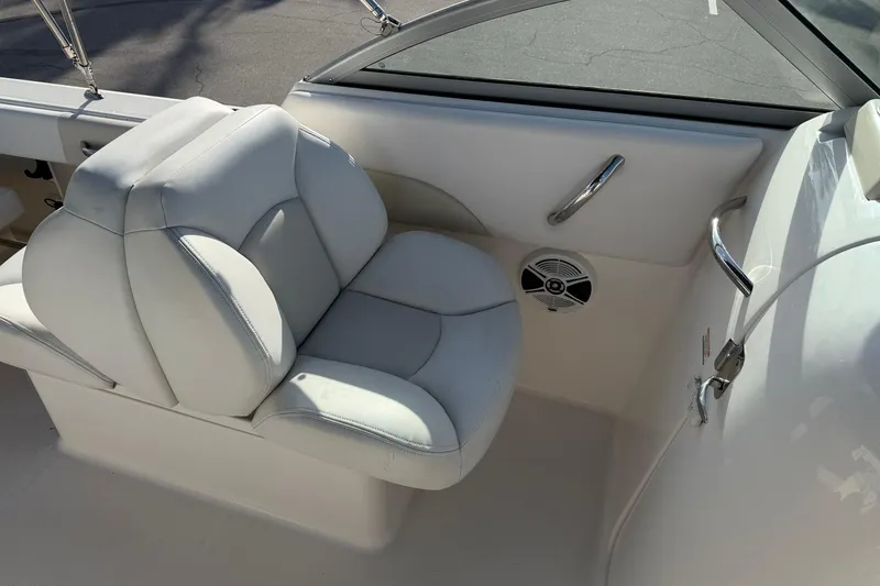 Slide: The Image of 2016 Robalo R227 Dual Console boat interior with white cushioned seating. - 15