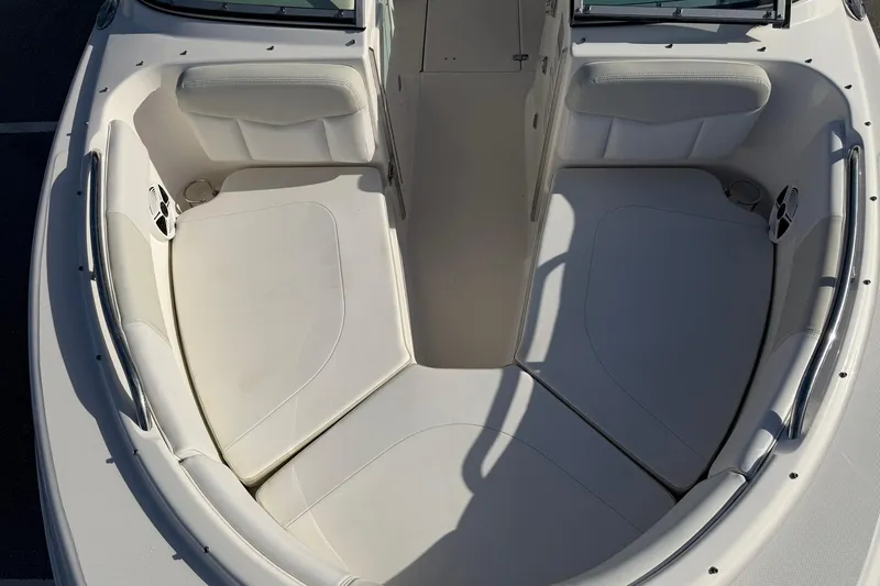 Slide: The Image of 2016 Robalo R227 Dual Console boat interior with white cushioned seating. - 21