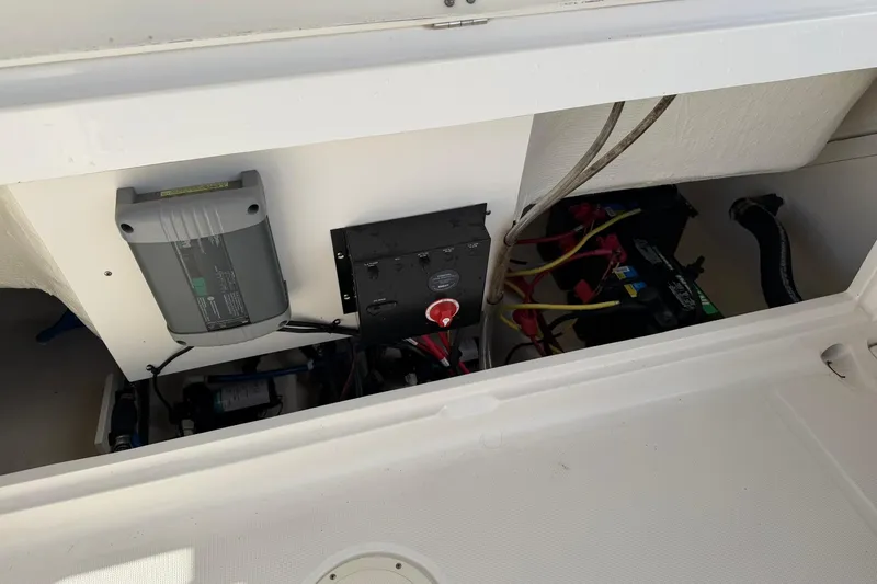 Slide: The Image of 2016 Robalo R227 Dual Console boat battery compartment with wiring and electrical components. - 24