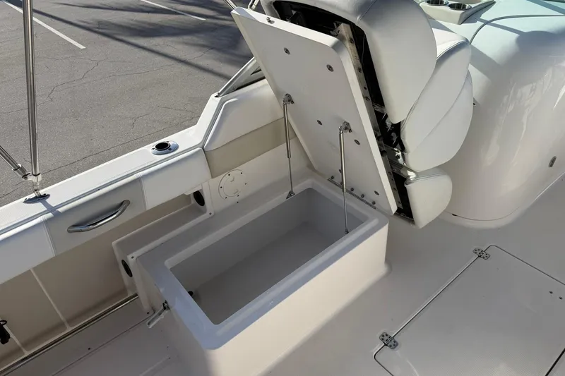 Slide: The Image of 2016 Robalo R227 Dual Console boat with open storage compartment and seating. - 26