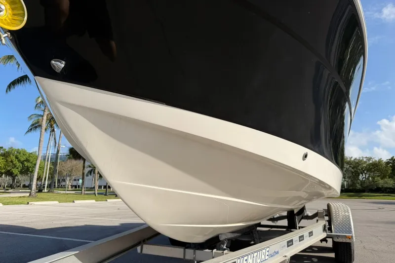 Slide: The Image of 2016 Robalo R227 Dual Console boat on trailer, parked outdoors. - 9
