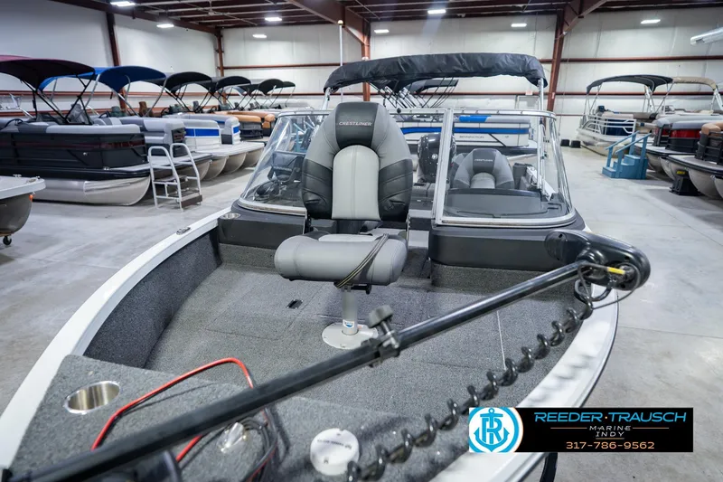 Slide: The Image of 2014 Crestliner 1650 Fish Hawk SE boat in showroom, featuring comfortable seating and modern design. - 12