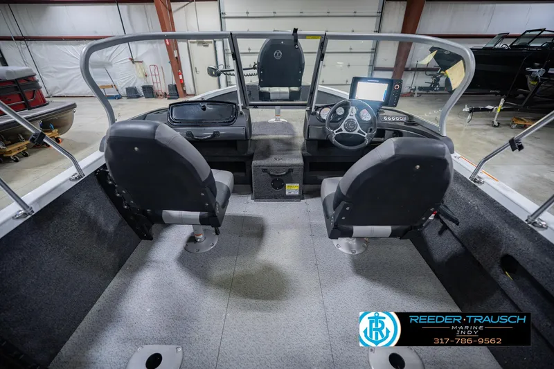 Slide: The Image of Interior of a 2014 Crestliner 1650 Fish Hawk SE boat with dual seats and control panel. - 16