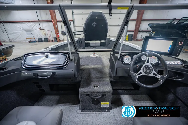 Slide: The Image of 2014 Crestliner 1650 Fish Hawk SE boat interior with steering wheel and dashboard controls. - 17