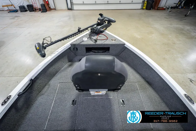 Slide: The Image of 2014 Crestliner 1650 Fish Hawk SE boat interior with trolling motor, showcased in a showroom. - 18