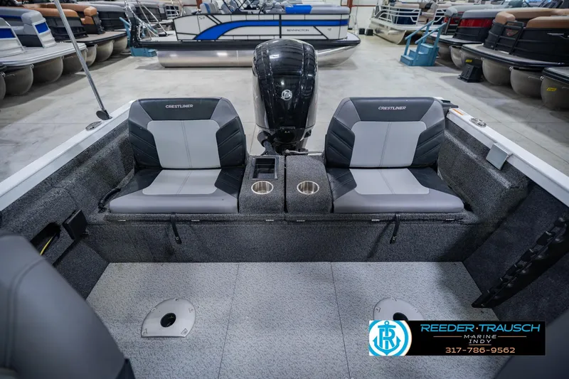 Slide: The Image of 2014 Crestliner 1650 Fish Hawk SE boat interior with dual seats and motor in showroom. - 21