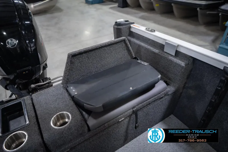 Slide: The Image of 2014 Crestliner 1650 Fish Hawk SE boat interior with motor and storage compartments. - 23