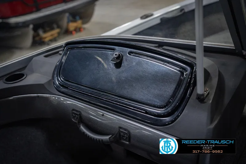 Slide: The Image of 2014 Crestliner 1650 Fish Hawk SE boat dashboard with storage compartment and handle. - 26