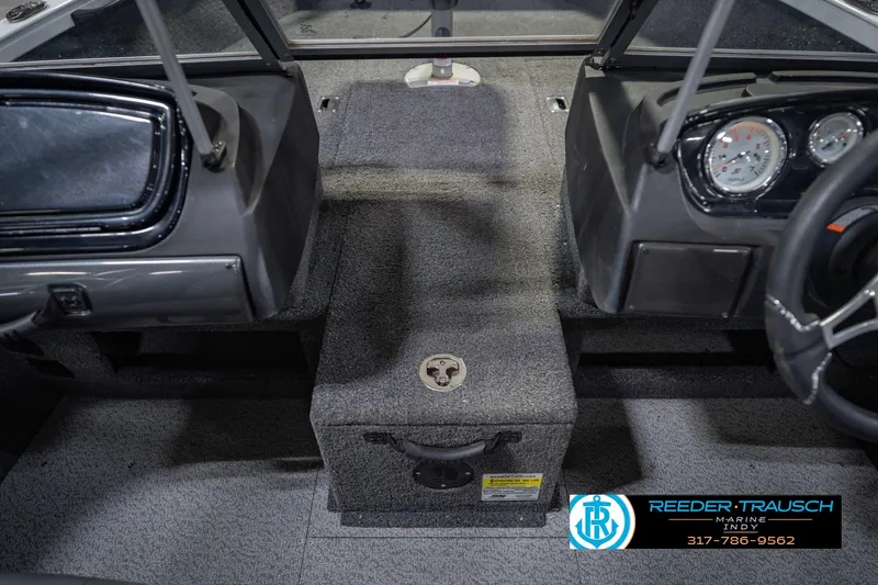 Slide: The Image of Interior view of a 2014 Crestliner 1650 Fish Hawk SE boat cockpit with dashboard and steering wheel. - 28