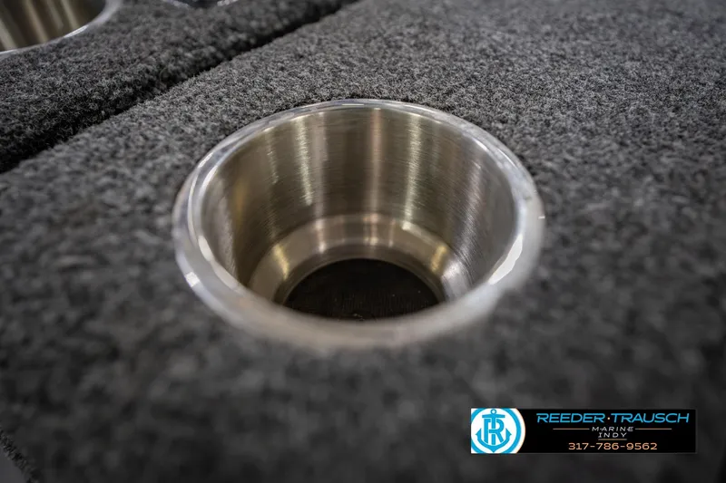 Slide: The Image of Cup holder on 2014 Crestliner 1650 Fish Hawk SE boat, featuring carpeted surface. - 44