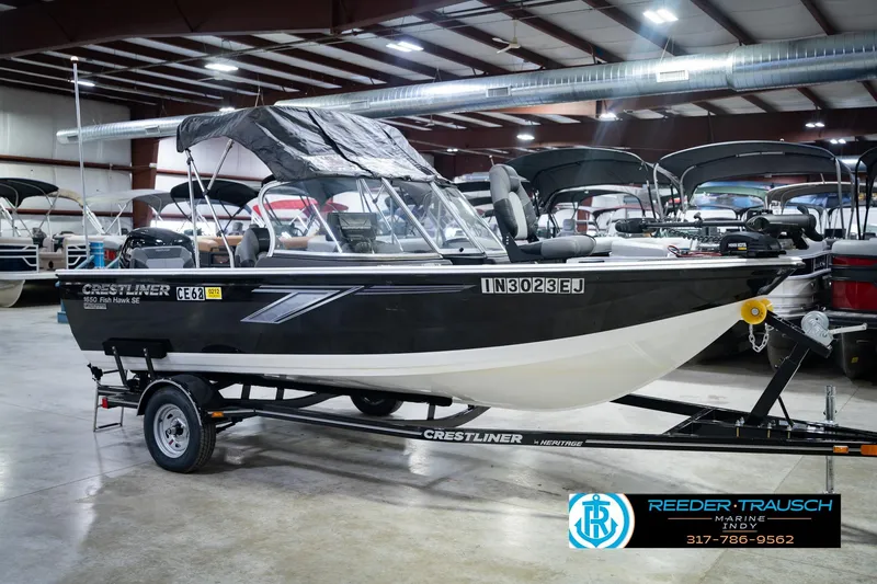 Slide: The Image of 2014 Crestliner 1650 Fish Hawk SE boat on trailer in indoor showroom. - 6