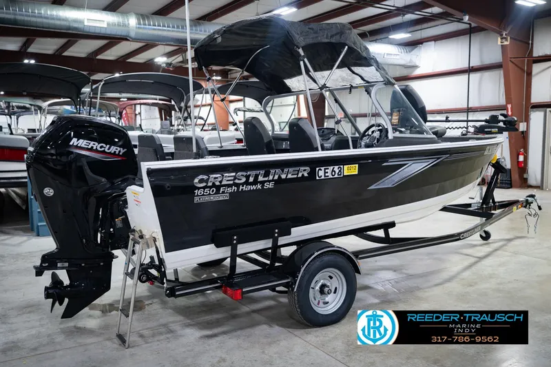 Slide: The Image of 2014 Crestliner 1650 Fish Hawk SE boat with Mercury engine in showroom. - 8