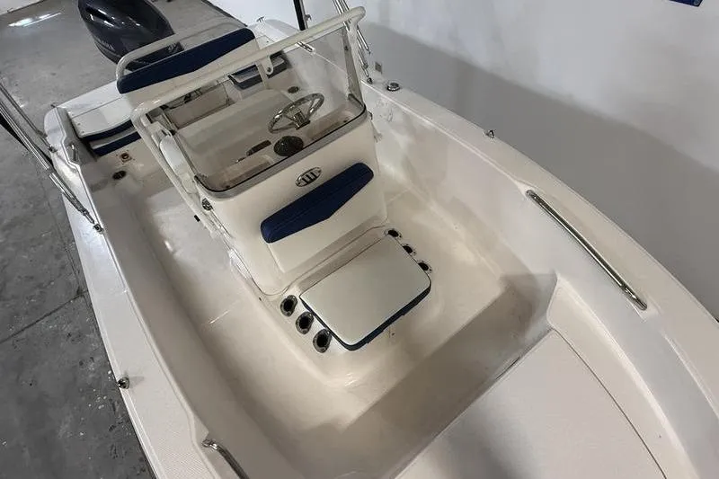 Slide: The Image of 2025 Robalo R160 Center Console boat interior with steering wheel and seating. - 10