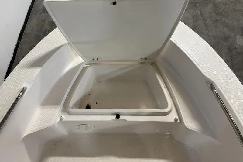 Slide: The Image of Open storage compartment on 2025 Robalo R160 Center Console boat. - 13