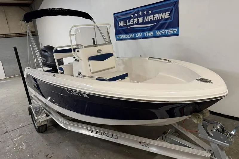 Slide: The Image of 2025 Robalo R160 Center Console boat on trailer at Miller's Marine showroom. - 2