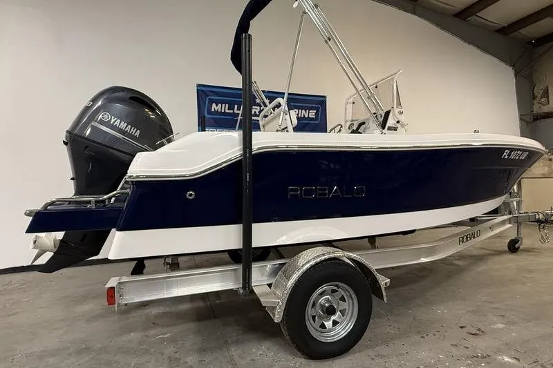 Slide: The Image of 2025 Robalo R160 Center Console boat on trailer with Yamaha engine in showroom. - 3