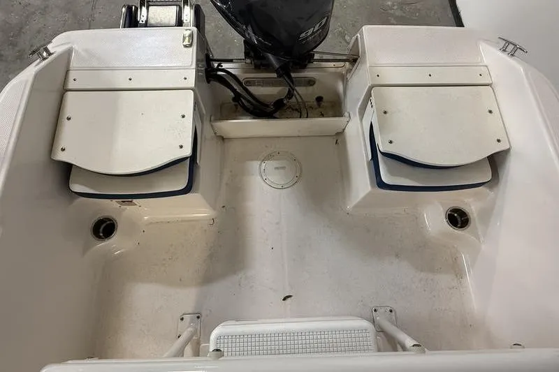 Slide: The Image of 2025 Robalo R160 Center Console boat interior with engine and seating. - 4