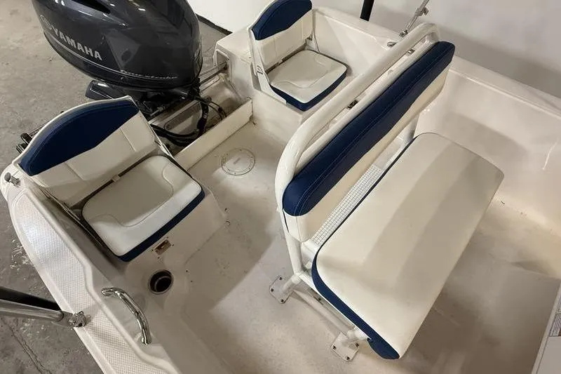 Slide: The Image of 2025 Robalo R160 Center Console boat interior with Yamaha engine, featuring blue and white seating. - 5