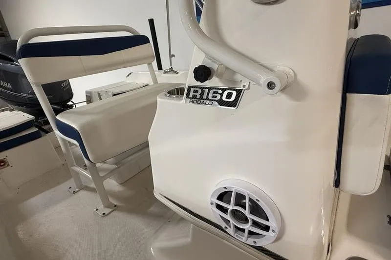 Slide: The Image of 2025 Robalo R160 Center Console interior with seating and speaker detail. - 7