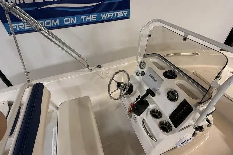Slide: The Image of 2025 Robalo R160 Center Console boat interior with steering wheel and controls. - 8