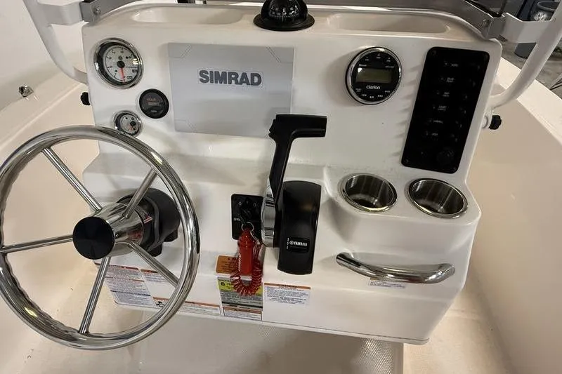 Slide: The Image of 2025 Robalo R160 Center Console dashboard with steering wheel and controls. - 9