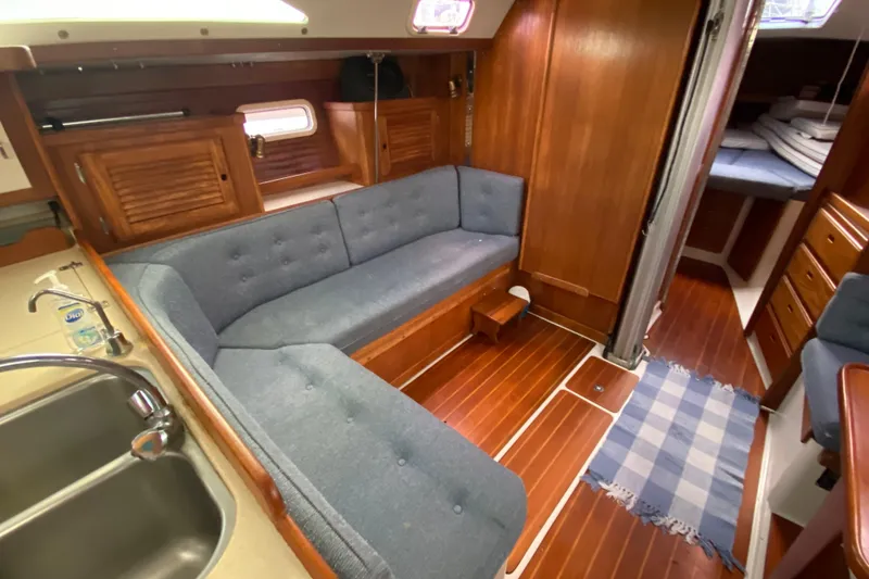 Slide: The Image of Interior of a 1998 Catalina 36 MkII sailboat with wooden finishes and blue upholstery. - 10