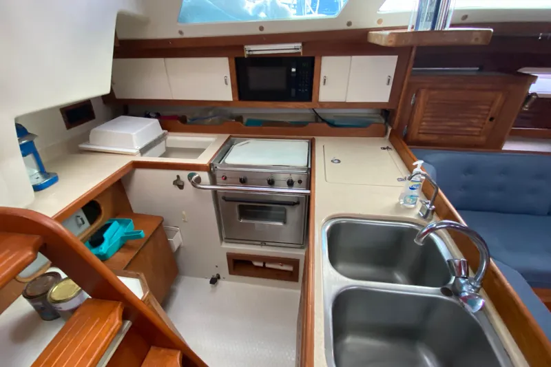Slide: The Image of Interior of 1998 Catalina 36 MkII yacht kitchen with stove, sink, and cabinetry. - 12